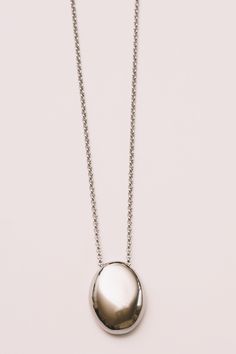 minimal necklace in silver pendant layering necklace in shiny finish on white background Minimalist Jewelry With Round Pendant Box Chain, Minimalist Jewelry With Box Chain And Round Pendant, Timeless Jewelry With Oval Pendant Cable Chain, Formal Jewelry With Oval Pendant And Cable Chain, Formal Oval Pendant With Cable Chain Jewelry, Formal Oval Pendant Jewelry With Cable Chain, Formal Oval Pendant With Cable Chain, Everyday White Gold Pendant Chain Necklace, White Gold Jewelry With Large Oval Pendant