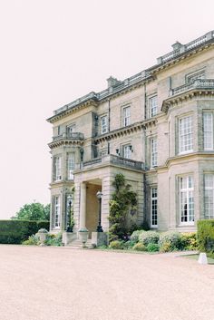 a large building with lots of windows and bushes