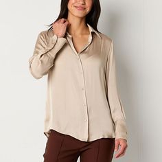 Crafted from airy satin, Worthington women's button-down blouse is cut for a loose fit with a spread collar, v-neckline, long sleeves, and button cuffs. Tuck it into a high-rise skirt or pants or layered over jeans for a casual look. Closure Type: ButtonFit: Relaxed FitNeckline: Collar NeckSleeve Length: Long SleeveSleeve Style: Cuffed SleeveApparel Length: 29 InchesFiber Content: 100% PolyesterFabric Description: SatinCollar: Point CollarCare: Tumble Dry, Machine WashCountry of Origin: Imported Satin Button-up Top With Buttons, Satin Button-up Blouse, Satin Button-up Shirt With Button Cuffs, Silk Button-up Blouse, Casual Satin Blouse For Workwear, High Rise Skirt, Button Front Shirt, Women Long Sleeve, Casual Looks