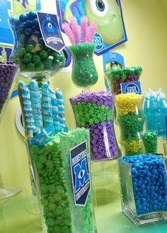 there are many candy in the vases on this table, including blue and green candies