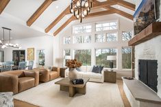 a living room filled with furniture and a fire place in the middle of a room