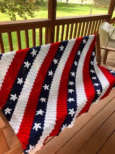 an american flag crocheted blanket on a porch