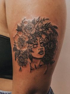 a woman with flowers on her head tattoo