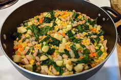 a pan filled with vegetables sitting on top of a stove