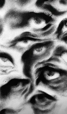 black and white photograph of an abstract pattern with eyes in the center, as if it were drawn on paper