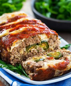 meatloaf stuffed with sauce and vegetables on a plate