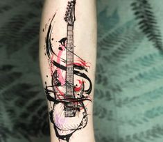 a person with a guitar tattoo on their arm