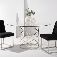 a glass table with two chairs around it