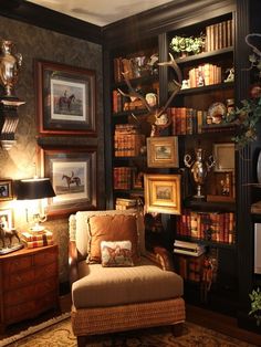 a living room filled with furniture and bookshelves covered in lots of shelves next to a lamp