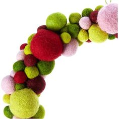 a close up of a stuffed animal made out of balls and pom poms