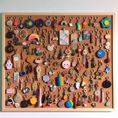 a cork board with many different types of earrings and earring hooks attached to it