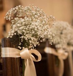 three vases with baby's breath flowers in them