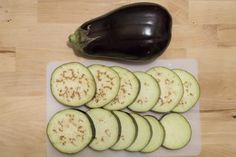 sliced up eggplant sitting on top of a cutting board