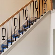 an image of a stair case with blue railings on the bottom and handrail