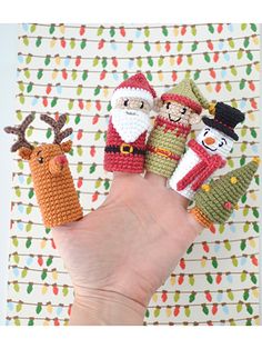 crocheted christmas finger puppets with santa, snowman, and reindeer on them