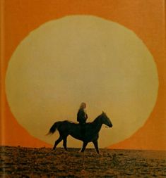 a person riding on the back of a horse in front of an orange and yellow sun