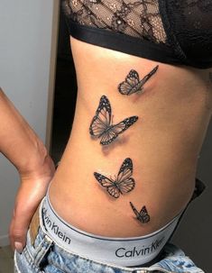 a woman's stomach with three butterflies on it and the words california written in black ink