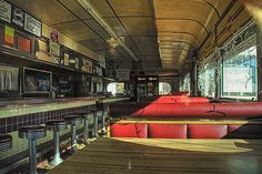 the inside of a restaurant with red seats