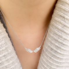 Soft and feminine, this Angel Wing Necklace is set in 14k gold on a 16-18" adjustable chain, and features 72 hand set diamonds. Elegant curves and neat rows of diamonds create a beautiful feathered wings effect. Angel Wing Necklace Silver, Elegant Wing-shaped Cubic Zirconia Jewelry, Elegant Angel Wings Necklaces, Elegant Wing-shaped White Gold Necklace, Elegant White Gold Wing-shaped Necklace, Elegant Sterling Silver Winged Necklace, Elegant Angel Wings Jewelry, Elegant Silver Winged Necklace, Elegant Winged Silver Necklace