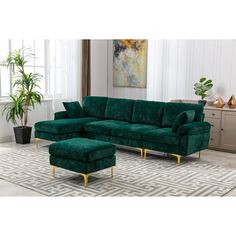 a green couch and ottoman in a living room