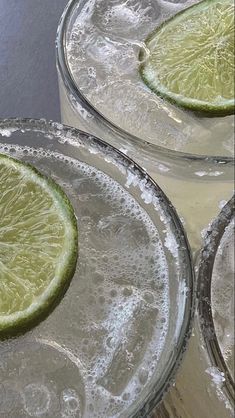 three glasses filled with water and lime slices