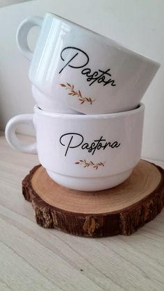 two white ceramic bowls sitting on top of a wooden stump with the word pasta written in italian