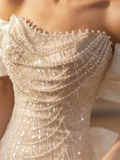 the back of a woman's dress with pearls on it