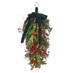 a christmas wreath hanging on the wall with lights and holly berries, pine cones and evergreen leaves