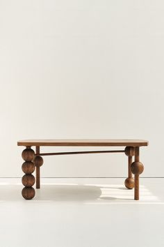 a wooden bench sitting on top of a white floor