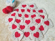 several crocheted hearts are arranged on the floor