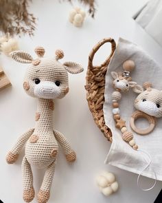 two crocheted giraffes sitting next to each other on a table