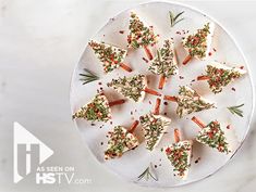 a white plate topped with cut up carrots covered in sprinkles and seasoning