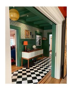 a room with green walls and black and white checkered floor