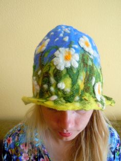 Beautiful hat with meadow of daisies on it. Unique hat in which you will feel amazingly good. Hat has a wide usage: it can be a sauna hat or a hat for a special occasion or teapot warmer. As a sauna hat it will protect your head and hair from the heat, as teapot cover it will keep the teapot warm. This hat is made of 100% wool using wet felting technique. Materials: New Zealand sheep wool 100% This hat is not on stock. This hat is made to order. Final product will be a little different than this Spring Brimmed Felt Hat, Spring Felt Brimmed Hats, Spring Wide Brim Felt Hat, Spring Curved Brim Felt Hat, Handmade Spring Costume Hats And Headpieces, Whimsical Crochet Hat With Curved Brim For Spring, Handmade Brimmed Felt Hat For Spring, Handmade Spring Short Brim Felt Hat, Whimsical Wide Brim Winter Hat