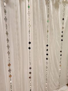 the curtain is covered with beads and other things hanging from it's sides,