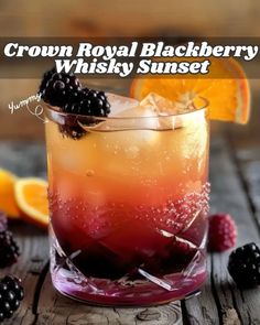 the crown royal blackberry whiskey sunset cocktail is garnished with blackberries and orange slices