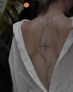 the back of a woman's neck with flowers on it