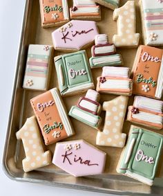 decorated cookies in the shape of books on a tray