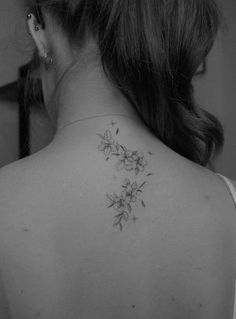 a woman with a flower tattoo on her back