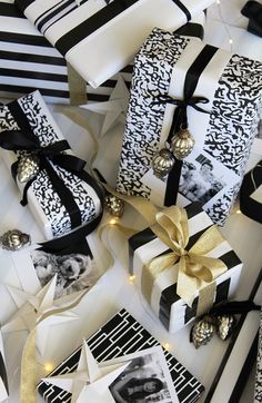 presents wrapped in black and white paper with gold ribbons