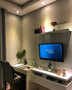 a flat screen tv sitting on top of a white desk