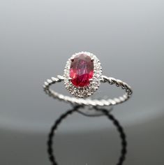 1.00ct Burma Unheat Ruby with 18K white gold antique band ring with diamonds This classic metamorphic ruby has clear unheat Burma characteristics reflecting an attractive and desirable red colour reflected by the common step cut formation. Elongated oval shape assisting in light attraction allowing its natural red colour bouncing off from your finger to an almost 180 degree wide angle which cannot be missed by any eye.  Surrounded by 0.35ct of brilliant round white diamonds graded G colour adds Oval Ruby Ring With Vvs Clarity Diamond, Classic Ruby Ring In Diamond White, Exquisite Oval Ruby Ring In White Gold, Oval Lab-created Ruby Diamond Ring In White Gold, Oval Ruby Halo Ring In White Gold, Oval White Gold Ruby Halo Ring, Fine Jewelry Lab-created Ruby Diamond Ring With Halo Design, Dazzling Oval White Gold Ruby Ring, Dazzling Oval Ruby Ring In White Gold