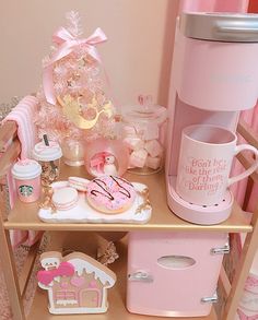 a doll house with pink furniture and accessories on the floor, including a coffee maker