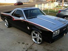 a black and red car parked on the street