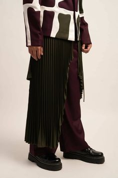 Made in IndiaThe Chaos Cascade Trousers & Skirt Set exudes opulence. Purple satin trousers flow into wide legs, while the pleated skirt, worn as a luxurious wrap around the waist, adds a dynamic touch. A lavish ensemble fit for elite gatherings and sophisticated affairs.FabricsShell: TR Suiting, IndiaMaintenance• Dry Clean Only• Do Not Bleach• Steam Iron OnlyModel is wearing UK Size Medium, Height 181 cmXS: 36 inches (bust), 33 inches (waist), 38 inches (hips)S: 38 inches (bust), 35 inches (wais Evening Pleated Asymmetrical Draped Skirt, Asymmetrical Pleated Maxi Skirt For Evening, Asymmetrical Pleated Skirt Bottoms For Evening, Chic Asymmetrical Pleated Bottoms, Elegant Wide Leg Pants With Accordion Pleats, Elegant Draped Bottoms For Workwear, Elegant Pleated Asymmetrical Bottoms, Elegant Asymmetrical Pleated Bottoms, Elegant Bottoms With Asymmetrical Hem For Formal Events