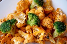 broccoli florets and cauliflower on a plate with a fork