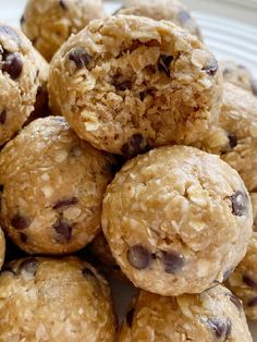 a pile of oatmeal chocolate chip cookies sitting on top of a white plate