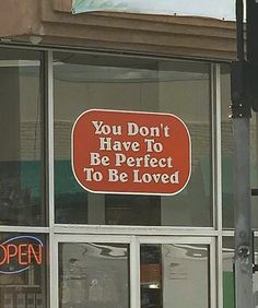 a red sign that says you don't have to be perfect to be loved