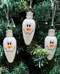 three glass christmas ornaments hanging from a tree