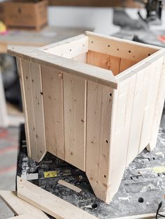 a wooden box sitting on top of a table next to other woodworking tools and supplies